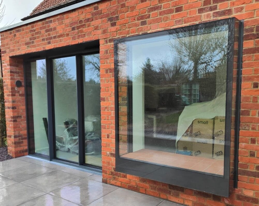 Oriel window and slim-framed sliding doors